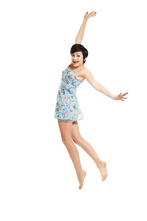 simsearch:400-06481645,k - Beautiful teenager with a blue dress dancing and jumping, isolated over white background Stock Photo - Budget Royalty-Free & Subscription, Code: 400-06633436