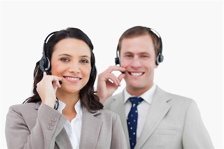 simsearch:400-03933798,k - Smiling call center team with their headsets against a white background Stock Photo - Budget Royalty-Free & Subscription, Code: 400-06685579