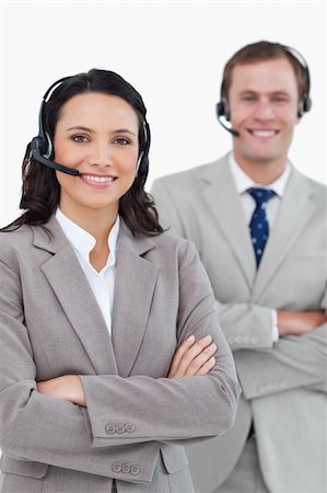 simsearch:400-03933798,k - Smiling call center agents with headsets and arms folded against a white background Stock Photo - Budget Royalty-Free & Subscription, Code: 400-06685572