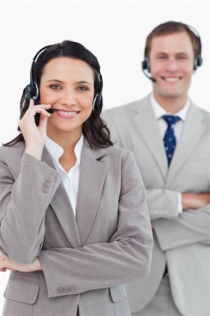 simsearch:400-03933798,k - Smiling call center agents with headsets on and arms folded against a white background Stock Photo - Budget Royalty-Free & Subscription, Code: 400-06685573