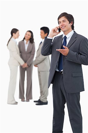 simsearch:859-06710917,k - Tradesman talking on the phone with team behind him against a white background Stock Photo - Budget Royalty-Free & Subscription, Code: 400-06686566