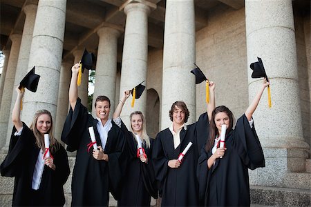 simsearch:400-06688304,k - Graduates holding up their hats in front of the university Photographie de stock - Aubaine LD & Abonnement, Code: 400-06688299