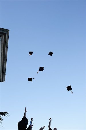 simsearch:400-06688304,k - Low angle-shot of grad students throwing their hats in the sky Photographie de stock - Aubaine LD & Abonnement, Code: 400-06688305