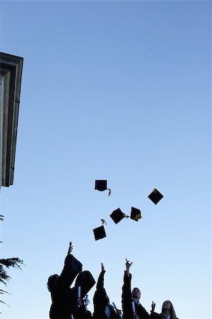 simsearch:400-06688304,k - Low angle-shot of five grad students throwing their hats in the sky Photographie de stock - Aubaine LD & Abonnement, Code: 400-06688303
