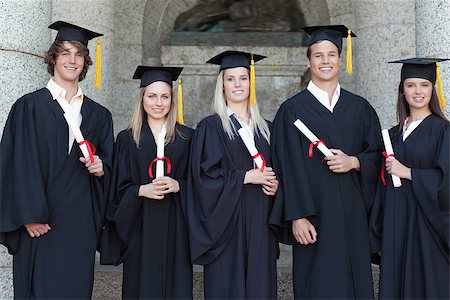 simsearch:400-06688304,k - Smiling graduates posing in front of the university Photographie de stock - Aubaine LD & Abonnement, Code: 400-06688399