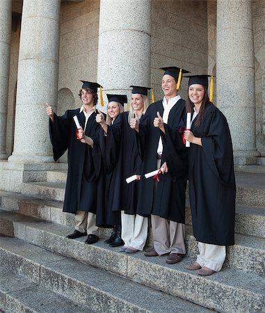 simsearch:400-06688304,k - Laughing graduates posing the thumb-up in front of the university Photographie de stock - Aubaine LD & Abonnement, Code: 400-06688405