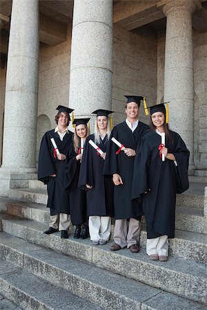 simsearch:400-06688304,k - Laughing graduates posing the thumb-up in front of the university Photographie de stock - Aubaine LD & Abonnement, Code: 400-06688406