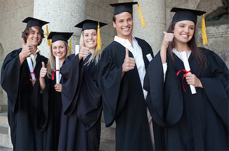 simsearch:400-06688304,k - Graduates posing the thumb-up in front of the university Photographie de stock - Aubaine LD & Abonnement, Code: 400-06688403