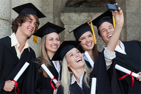 simsearch:400-06688304,k - Close-up of happy graduates taking a picture of themselves in front of the university Photographie de stock - Aubaine LD & Abonnement, Code: 400-06688415