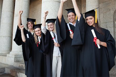 simsearch:400-06688304,k - Five happy graduates posing the arm raised in front of the university Photographie de stock - Aubaine LD & Abonnement, Code: 400-06688410