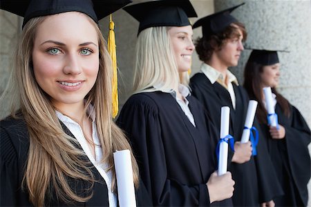 simsearch:400-06688304,k - Close-up of a blonde graduate with blue eyes next to her friends posing Photographie de stock - Aubaine LD & Abonnement, Code: 400-06688429