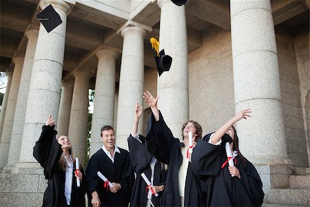 simsearch:400-06688304,k - Graduates throwing their hats in the sky in front of their university Photographie de stock - Aubaine LD & Abonnement, Code: 400-06688435