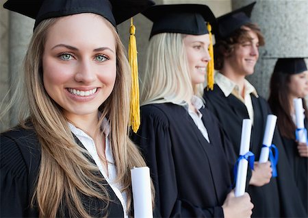 simsearch:400-06688304,k - Close-up of a beautiful graduate with blue eyes next to her friends posing Photographie de stock - Aubaine LD & Abonnement, Code: 400-06688430