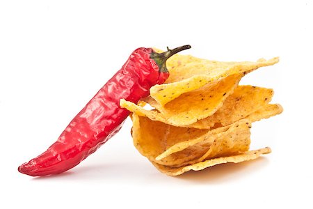 pimento - Pepper beside a small stack of crisps against white background Stock Photo - Budget Royalty-Free & Subscription, Code: 400-06689583