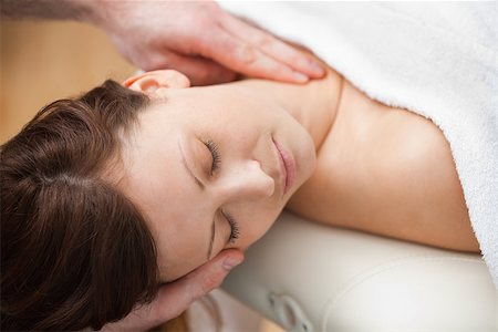 Doctor holding the head of a woman while massaging her neck in a room Stock Photo - Budget Royalty-Free & Subscription, Code: 400-06689838