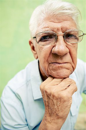 simsearch:400-06142278,k - people and emotions, portrait of depressed senior hispanic man with glasses looking at camera, leaning with hands on chin Stock Photo - Budget Royalty-Free & Subscription, Code: 400-06694841