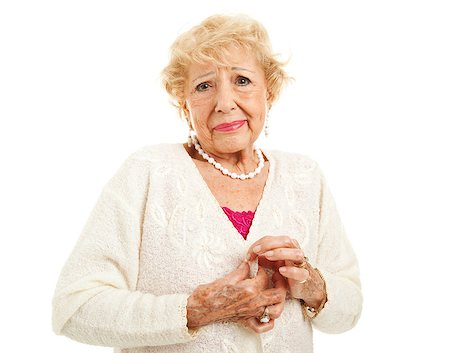 Senior woman with arthritis is having trouble buttoning her sweater. Isolated on white. Stock Photo - Budget Royalty-Free & Subscription, Code: 400-06695194