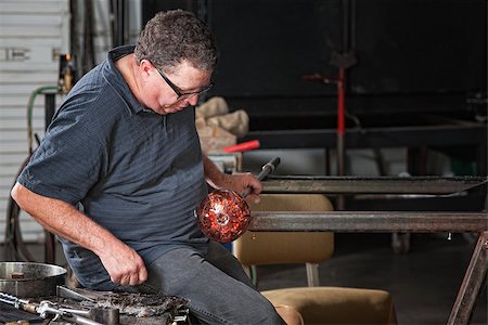 Glass craftsman holding rod with glass object cooling Stock Photo - Budget Royalty-Free & Subscription, Code: 400-06696174