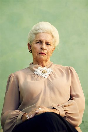 simsearch:400-06142278,k - Elderly women and feelings, portrait of serious senior caucasian woman with severe look staring at camera on green background Stock Photo - Budget Royalty-Free & Subscription, Code: 400-06699039