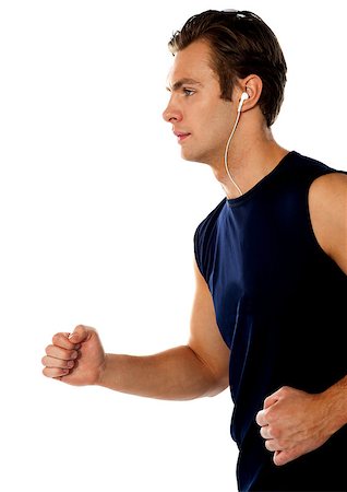 simsearch:400-06482604,k - Fit athlete enjoying music in a jogging posture wearing sporty outfit Stock Photo - Budget Royalty-Free & Subscription, Code: 400-06699792
