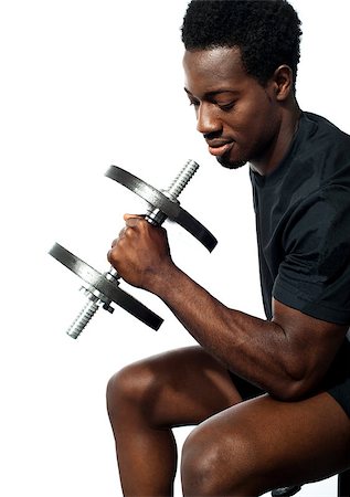simsearch:400-06859193,k - Portrait of happy fit african man working out with dumbbell Stock Photo - Budget Royalty-Free & Subscription, Code: 400-06699821