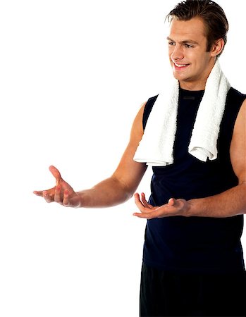simsearch:400-06482604,k - Male trainer posing with open hands and looking away. Studio shot Stock Photo - Budget Royalty-Free & Subscription, Code: 400-06699834