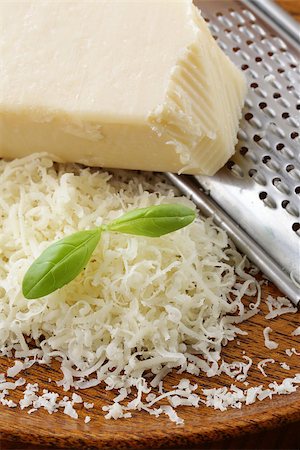 romano - grated parmesan cheese and metal grater on wooden plate Stock Photo - Budget Royalty-Free & Subscription, Code: 400-06699849