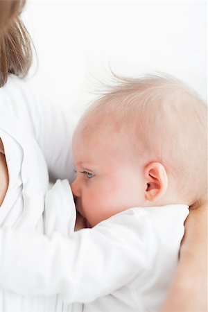 Mother breastfeeding her baby against a white background Foto de stock - Super Valor sin royalties y Suscripción, Código: 400-06690867