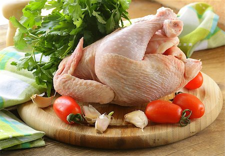 fresh raw chicken on a cutting board with vegetables and herbs Stock Photo - Budget Royalty-Free & Subscription, Code: 400-06700663