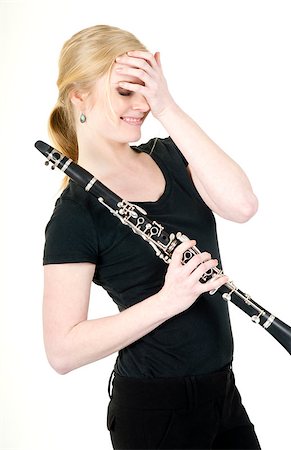 Beautiful Female Musician Blushes after Receiving Praise for Music on Clarinet Stock Photo - Budget Royalty-Free & Subscription, Code: 400-06700903