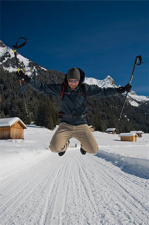 simsearch:400-04269017,k - Young man jumping on a snowy trail in val di fassa, in the dolomites Photographie de stock - Aubaine LD & Abonnement, Code: 400-06700998