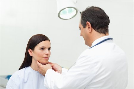 Doctor auscultating the neck of his patient in an examination room Stock Photo - Budget Royalty-Free & Subscription, Code: 400-06734168