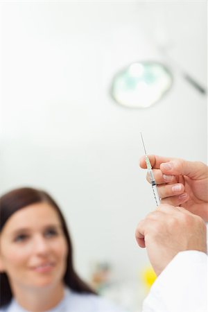 Doctor preparing an injection for a patient in an examination room Stock Photo - Budget Royalty-Free & Subscription, Code: 400-06734172