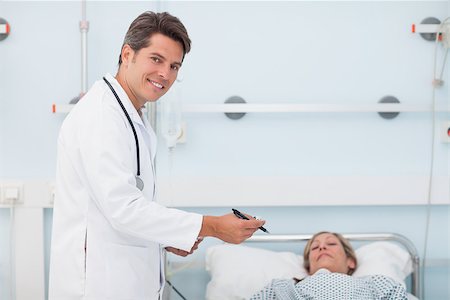 Doctor standing next to his patient in a hospital ward Stock Photo - Budget Royalty-Free & Subscription, Code: 400-06734184