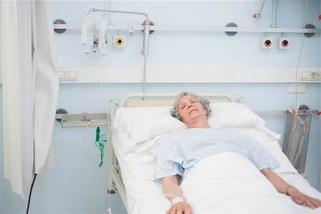 Elderly patient sleeping on a medical bed in hospital ward Stock Photo - Budget Royalty-Free & Subscription, Code: 400-06734201