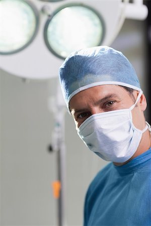 simsearch:400-06734297,k - Close up of a doctor looking at camera in operating theater Stock Photo - Budget Royalty-Free & Subscription, Code: 400-06734297