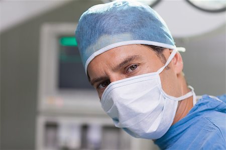 simsearch:400-06734297,k - Earnest doctor looking at camera in operating theater Stock Photo - Budget Royalty-Free & Subscription, Code: 400-06734299