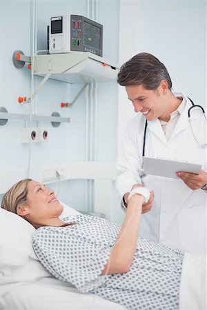 Doctor smiling to his patient in hospital ward Stock Photo - Budget Royalty-Free & Subscription, Code: 400-06734389