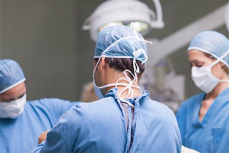 simsearch:400-06734297,k - Medical team working in operating theater Stock Photo - Budget Royalty-Free & Subscription, Code: 400-06734478
