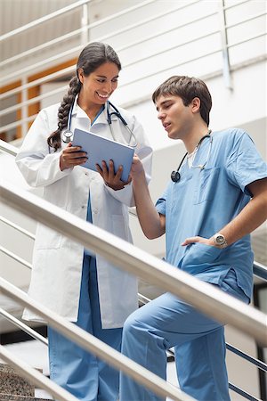 Doctor showing a tablet pc to a nurse in hospital Stock Photo - Budget Royalty-Free & Subscription, Code: 400-06734485