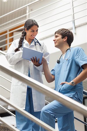 Doctor and a male nurse talking in hospital Stock Photo - Budget Royalty-Free & Subscription, Code: 400-06734486