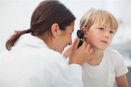 Doctor auscultating the ear of a child in examination room Stock Photo - Budget Royalty-Free & Subscription, Code: 400-06734644