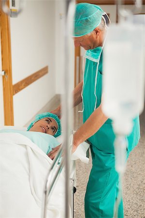Patient lying on a bed smiling to a surgeon in hospital corridor Stock Photo - Budget Royalty-Free & Subscription, Code: 400-06734784