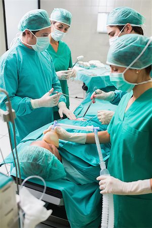 Nurse holding an oxygen mask of patient in an operating theatre Stock Photo - Budget Royalty-Free & Subscription, Code: 400-06735479