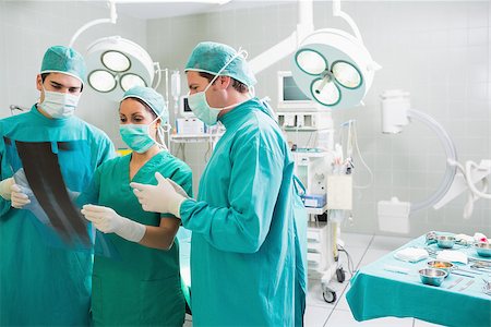 Medical team talking about a X-ray in an operating theatre Stock Photo - Budget Royalty-Free & Subscription, Code: 400-06735536