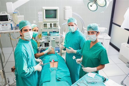 Group of surgeon working on a patient in an operating theater in a hospital Stock Photo - Budget Royalty-Free & Subscription, Code: 400-06735555