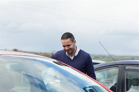 Buyer looking inside a car on a parking Stock Photo - Budget Royalty-Free & Subscription, Code: 400-06733777