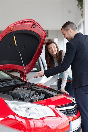 Dealer showing the car engine in a garage Stock Photo - Budget Royalty-Free & Subscription, Code: 400-06733836