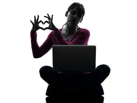 one caucasian woman heart gesture computing laptop computer  in silhouette studio isolated on white background Stock Photo - Budget Royalty-Free & Subscription, Code: 400-06748295