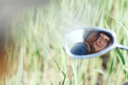 portrait of a young girl in a motorcycle mirror Stock Photo - Budget Royalty-Free & Subscription, Code: 400-06748913